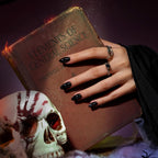 Close-up of Black Velvet almond press-on nails handmade gel polish